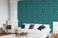 Berry Branch Symphony wallpaper behind a white sofa and ornate tiled stove in a living room
