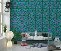 Berry Branch Symphony wallpaper in green and purple behind a child's daybed with plush toys in a kids room