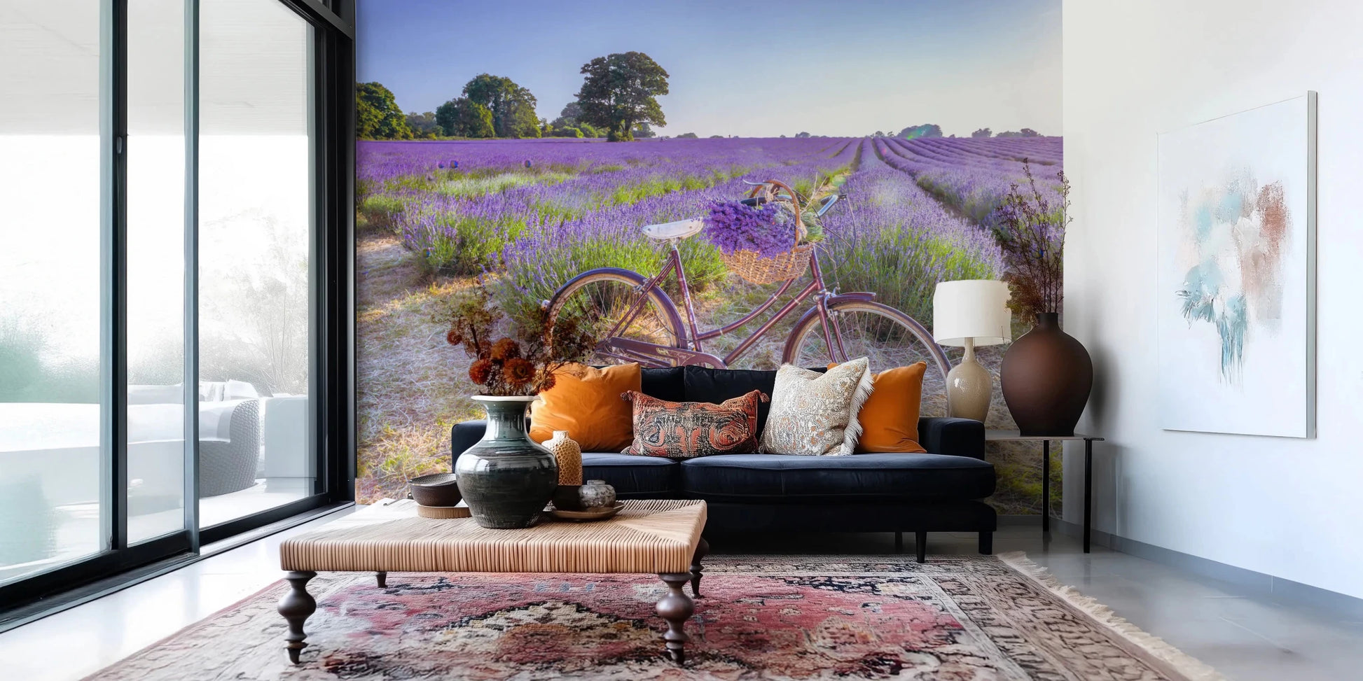 Bicycle in Lavender field wallpaper mural of a bike in lavender behind a navy sofa with orange pillows in a living room
