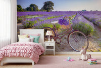 Bicycle in Lavender field wallpaper mural of a bike in lavender above a pink bed and unicorn toy in a girls bedroom