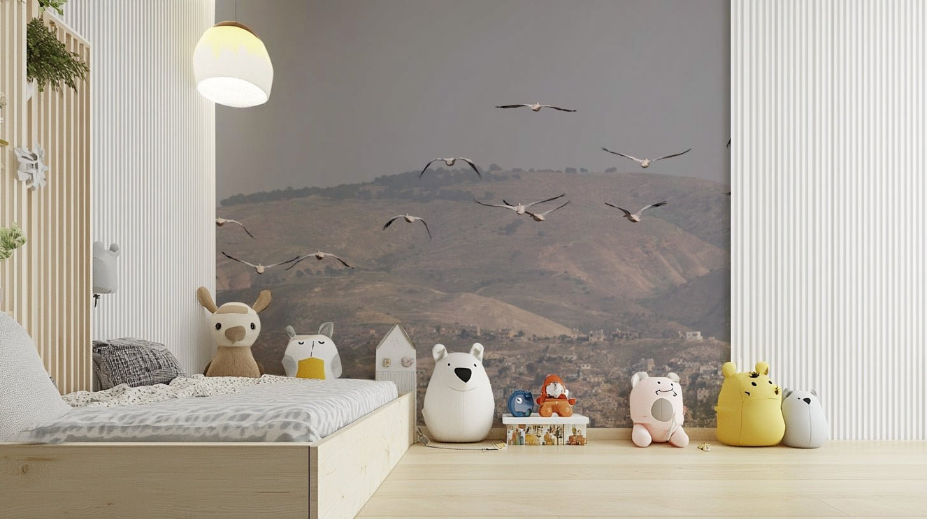 Features birds flying gracefully in an open sky.
