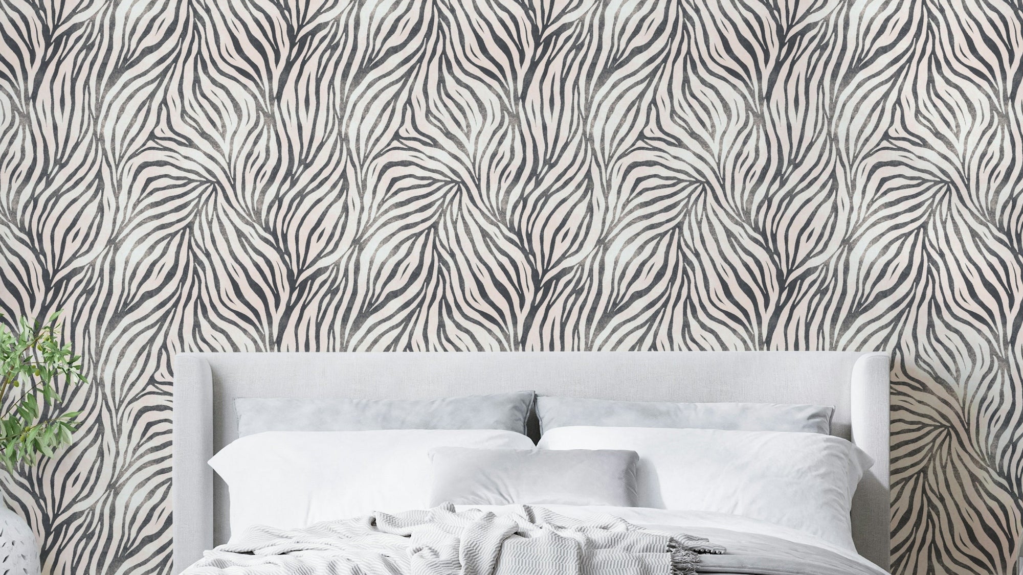 Black and White Boho Zebra wallpaper in a bedroom with a grey headboard, white bedding and striped throw