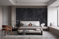Black Gray Marble wallpaper mural behind an upholstered bed and rust armchair in a modern bedroom