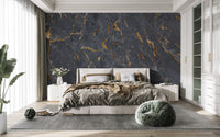 Dark stone wall mural behind a minimalist master bedroom headboard.