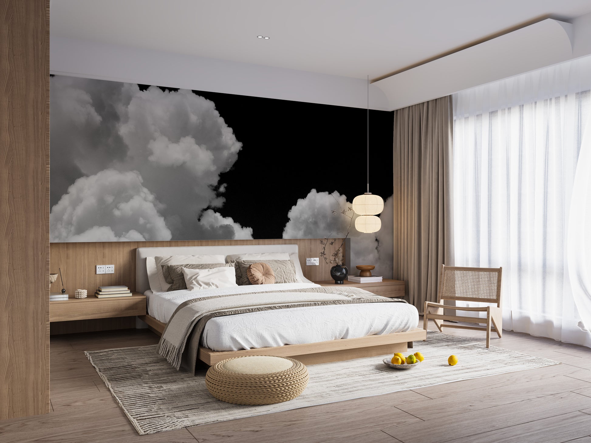 Black and white Clouds mural of white clouds on black above a low wood bed with beige bedding and a rattan chair