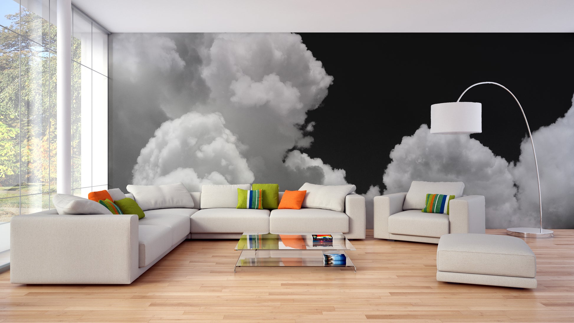 Black and white Clouds mural of white clouds on black behind a white sectional with orange and green cushions