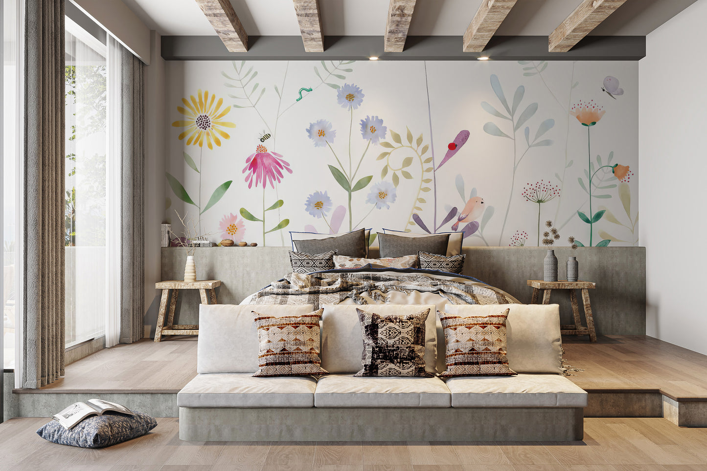 Bloom and Bird wallpaper mural of bright wildflowers and birds behind a platform bed with boho pillows in a beamed bedroom
