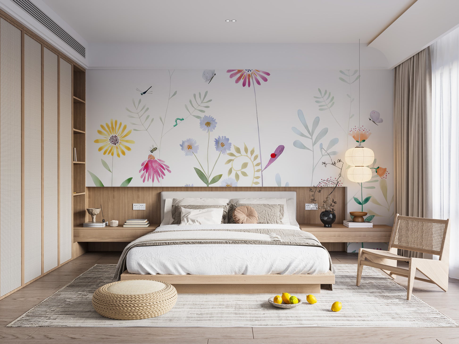 Bloom and Bird wallpaper mural of watercolor flowers above a low wood platform bed and rattan chair in a bedroom