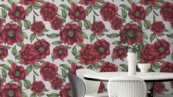 Blooming Camellias wallpaper mural with red camellia flowers and green leaves above a white round dining table and chairs