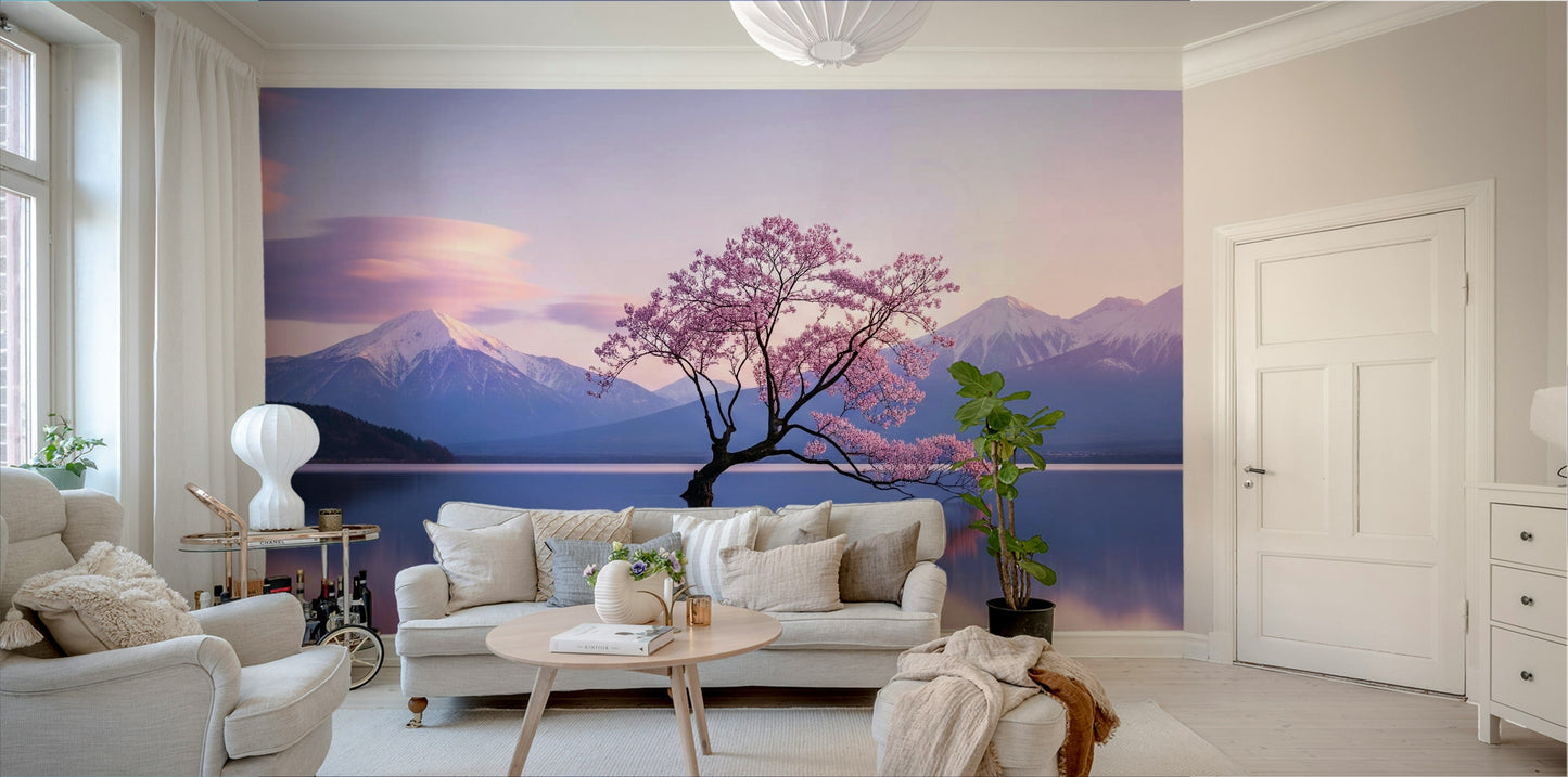 A beautiful serene landscape of mountains and blossoms reflecting in water.