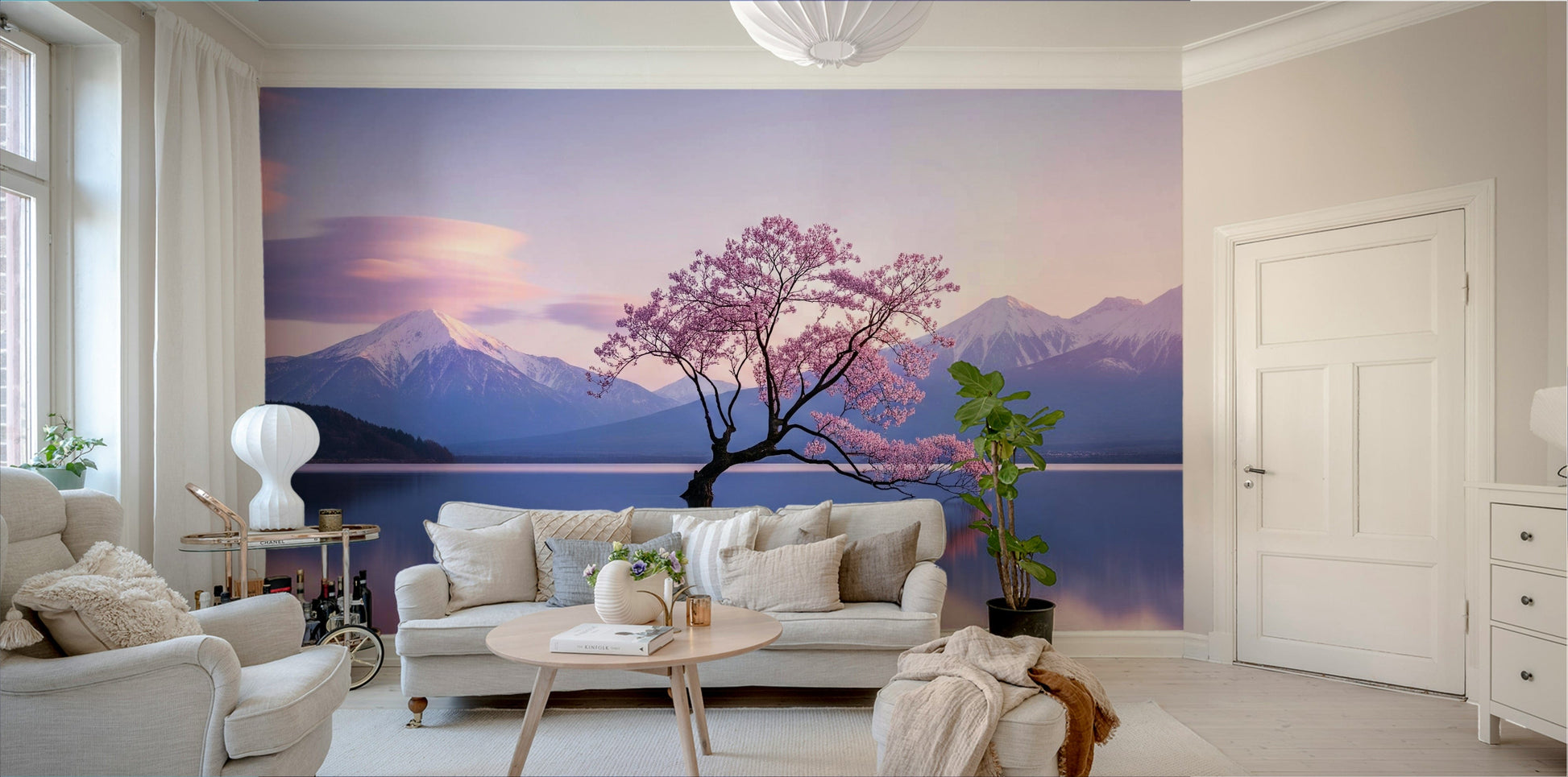A beautiful serene landscape of mountains and blossoms reflecting in water.