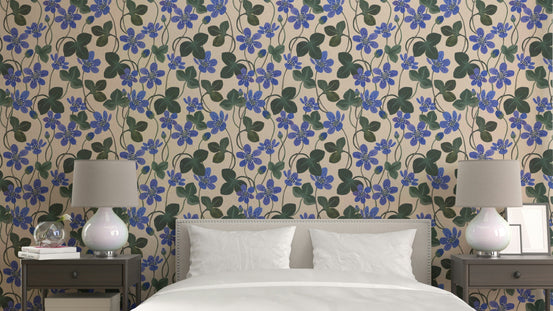 Blue Anemone wallpaper with cobalt flowers and green leaves behind a bed flanked by two matching table lamps