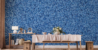 Blue Bird Flower wallpaper mural in blue florals behind a wooden bench and console table with a lamp