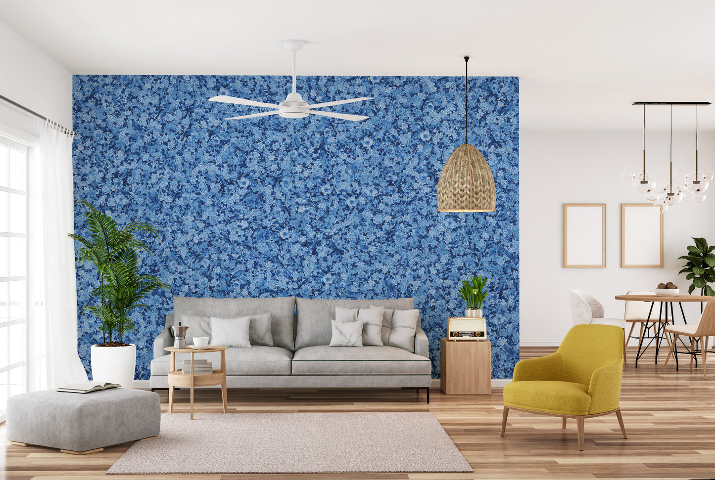 Blue Bird Flower wallpaper mural in blue florals behind a grey sofa and yellow armchair in a living room