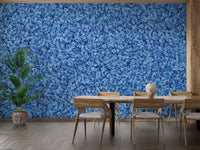 Blue Bird Flower wallpaper mural in dense blue floral pattern behind a wooden dining table and chairs