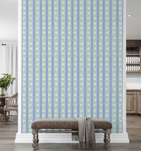 Blue Bloom Stripes wallpaper mural on a divider wall above a brown velvet bench, light blue stripes with yellow daisies