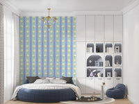 Blue Bloom Stripes wallpaper mural in a kids room with a round blue bed and white toy shelves, blue and yellow