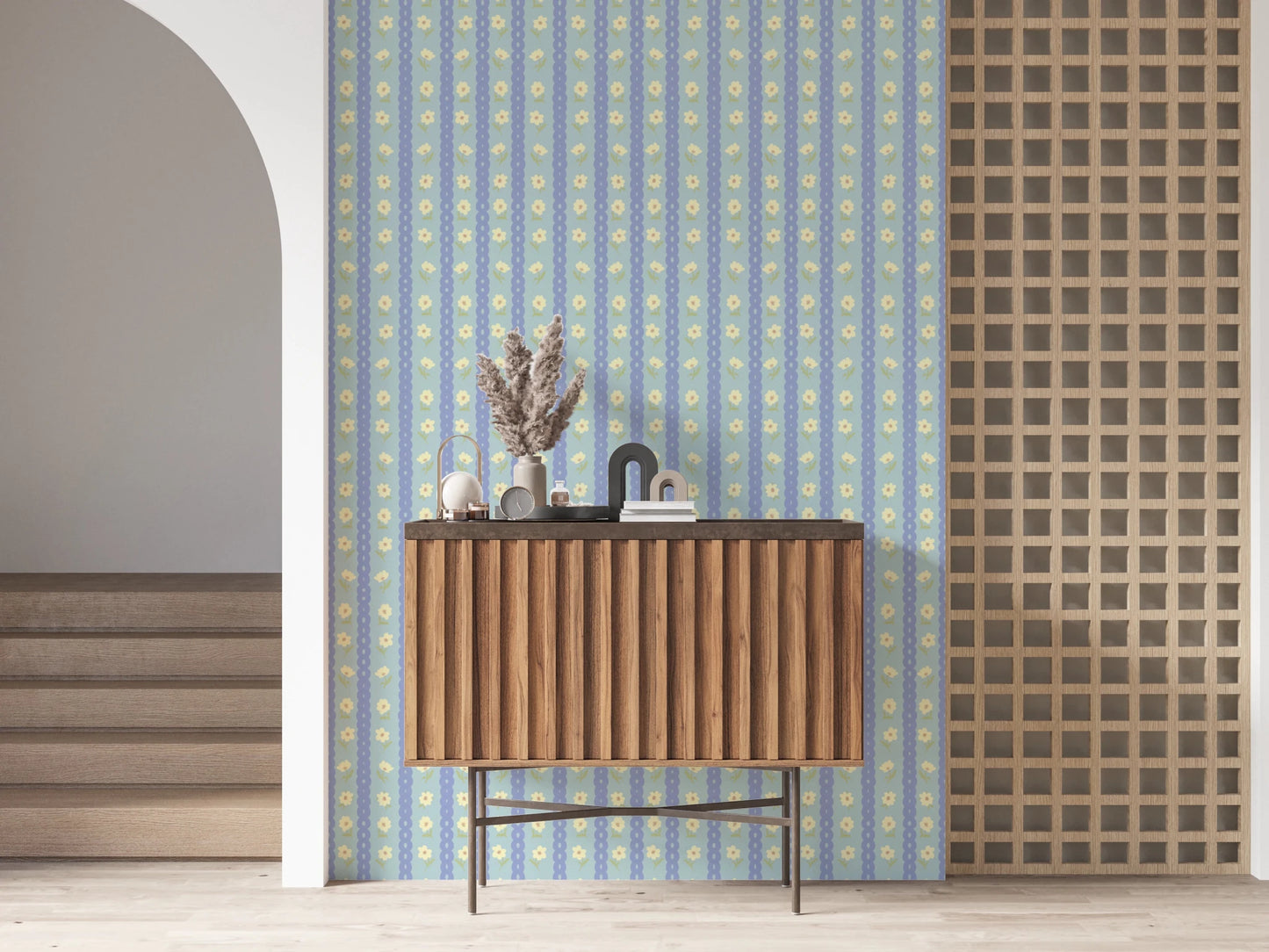 Blue Bloom Stripes wallpaper mural in an entryway behind a fluted walnut console with dried pampas grass