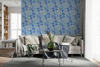 Blue bouquet tile wallpaper behind open shelves in modern kitchen, glossy tile feel