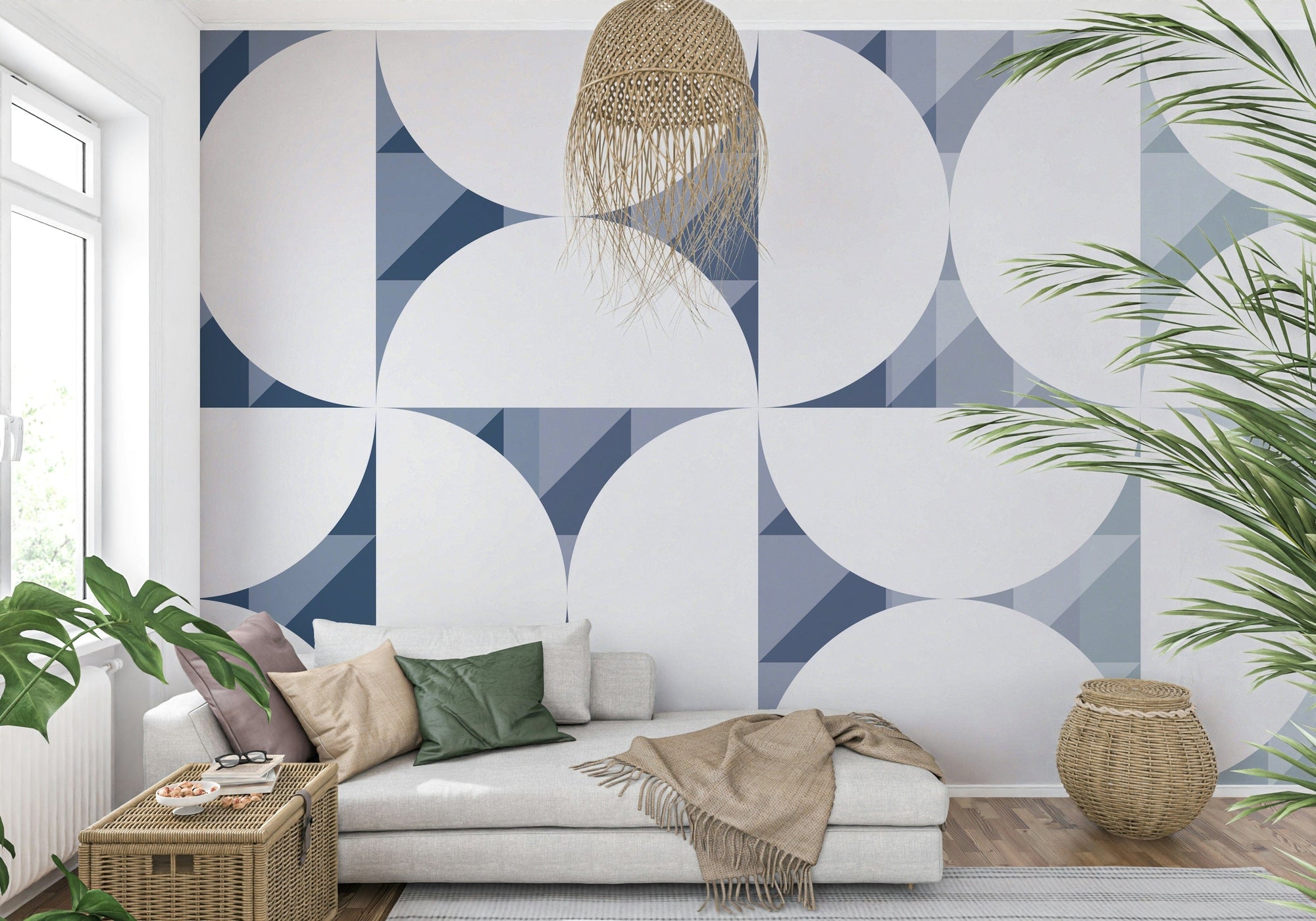 Blue Circle Dance wallpaper mural with navy and white Bauhaus circles behind a cream daybed in a living room