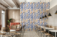 Watercolor botanical pattern with layered blue leaves and gold accents.