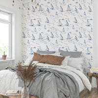 An angled shot of a wall with sailboat wallpaper

