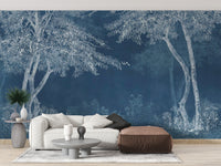 Blue Woods wallpaper mural styled as a feature wall behind a dining table and chairs in blue tones