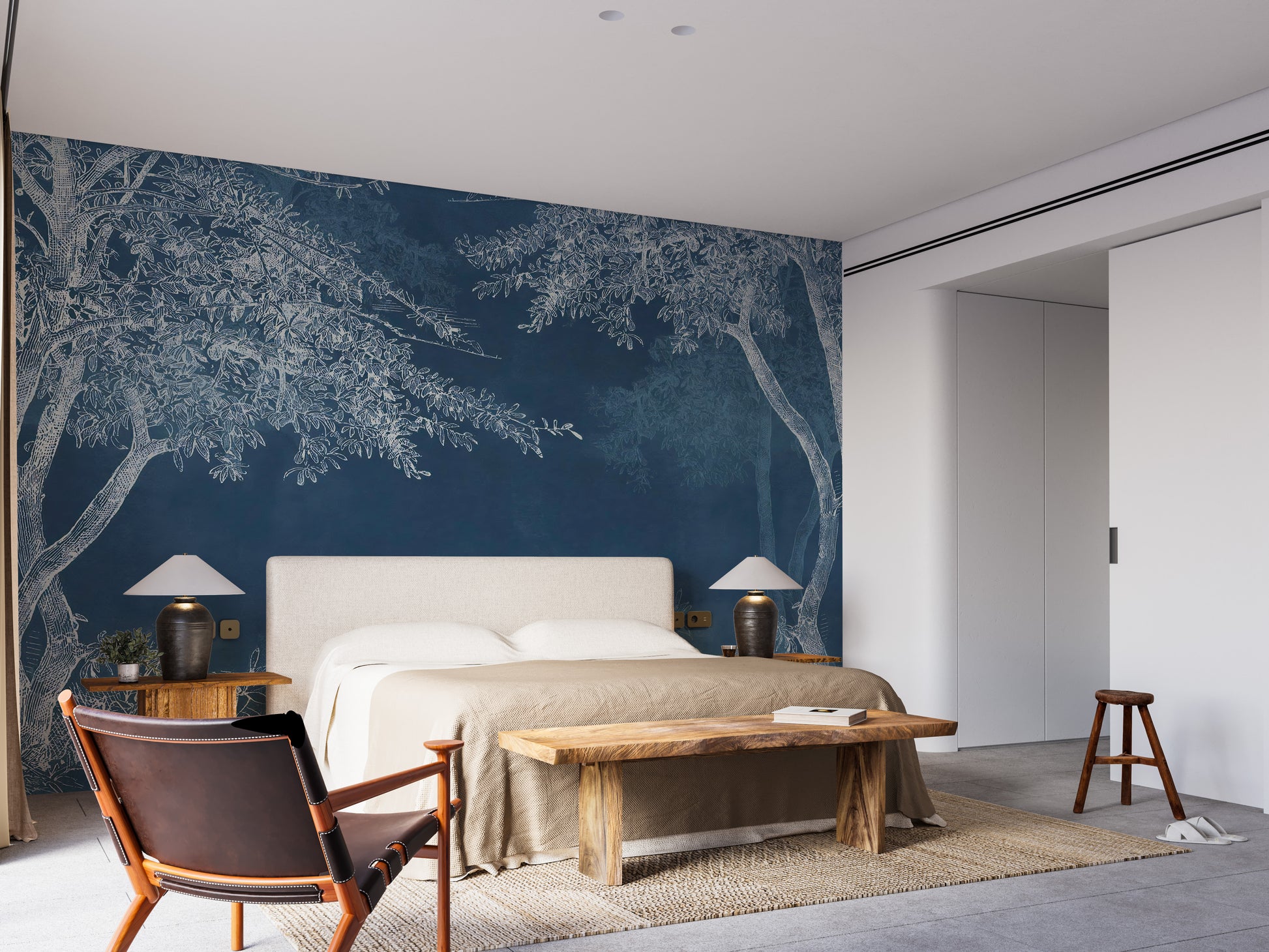Blue Woods wallpaper mural as a bedroom feature wall behind the headboard in blue tones