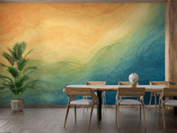 Blue & Yellow Watercolor Ombre wallpaper mural styled as a feature wall behind a dining table and chairs in blue tones