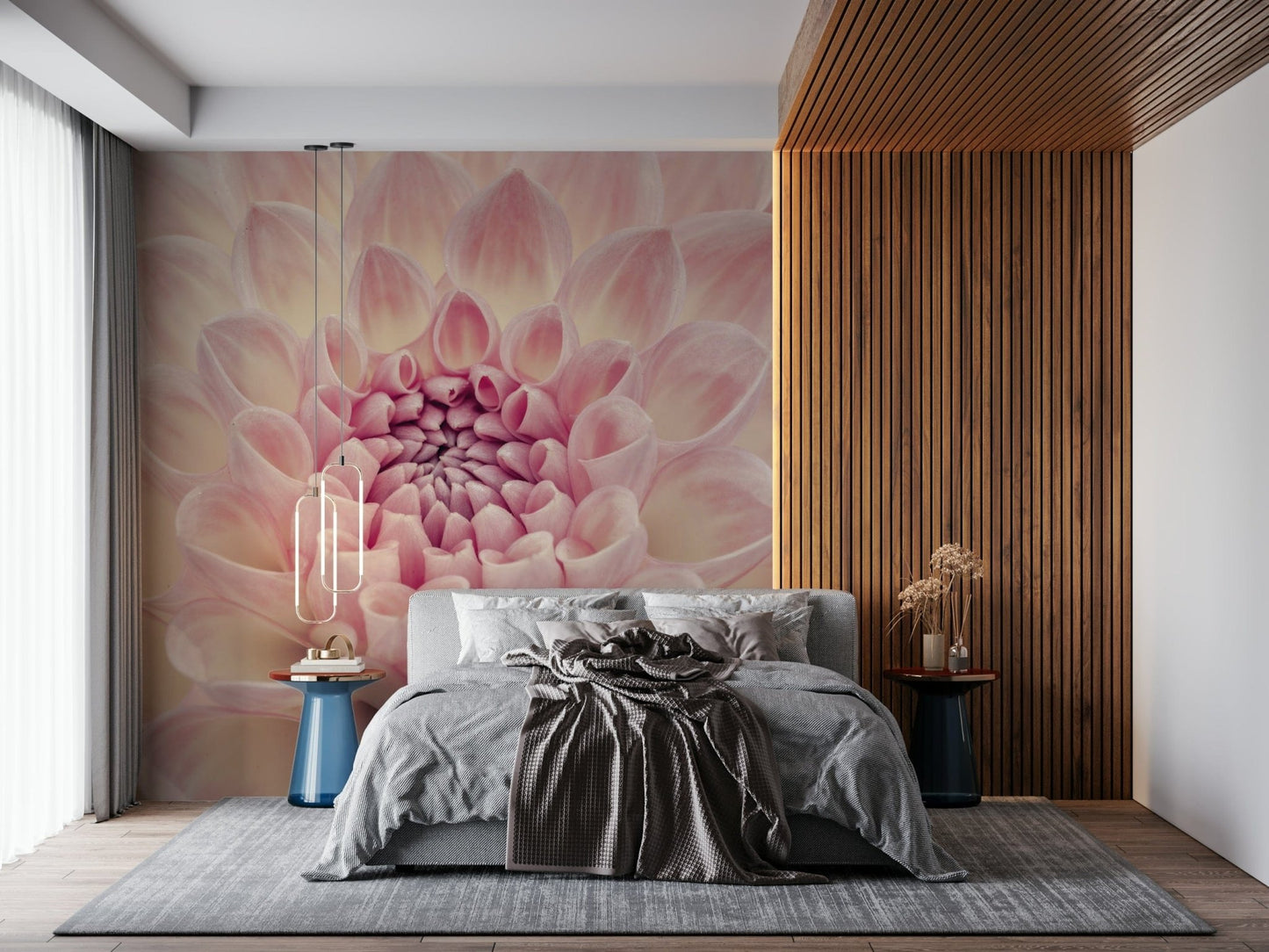 Blush Bloom wallpaper mural of a close-up pink dahlia behind a grey bed beside a wood slat wall in a bedroom