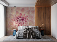 Blush Bloom wallpaper mural of a close-up pink dahlia behind a grey bed beside a wood slat wall in a bedroom