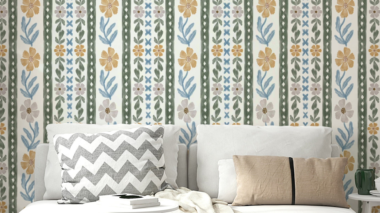 Blush pink and blue leaves wallpaper on living room wall

