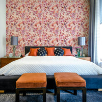 Coral and blush flowers on tropical-style wall

