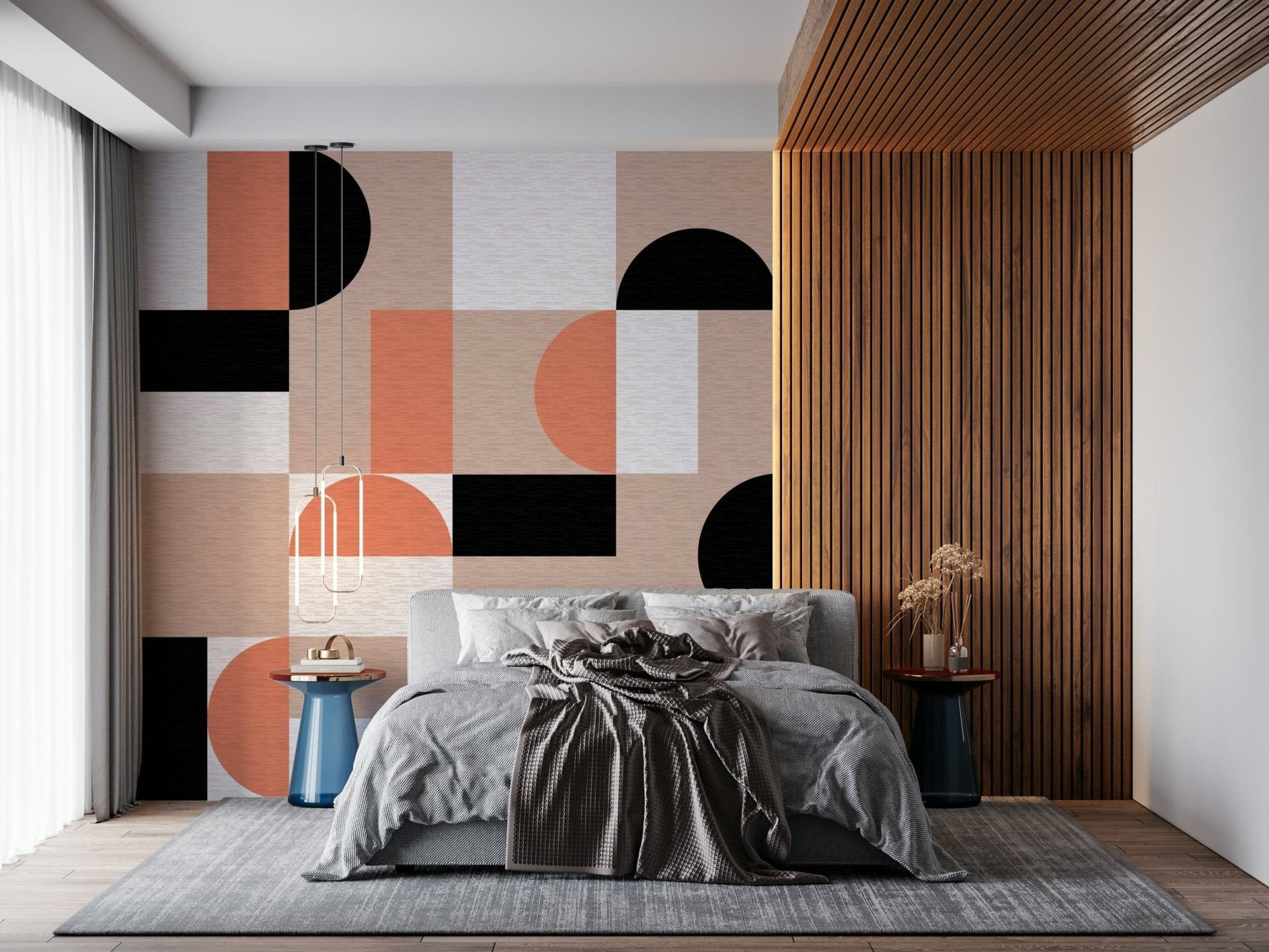 Blush Geometry wallpaper mural beside a wood-slat wall behind a grey bed with blue side tables