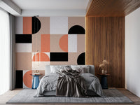 Blush Geometry wallpaper mural beside a wood-slat wall behind a grey bed with blue side tables