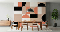 Blush Geometry wallpaper mural behind a wooden dining table and chairs with a black dome pendant lamp