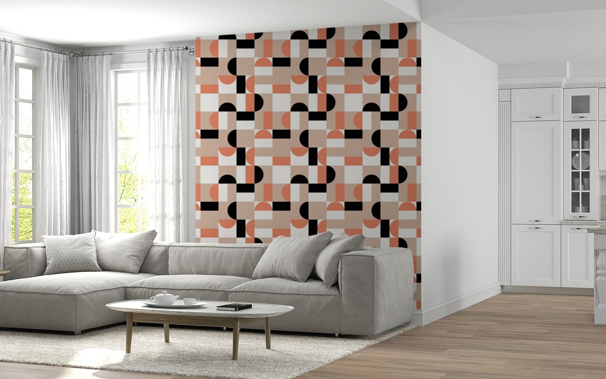 Blush Geometry wallpaper in blush and black accenting a wall above a grey sectional sofa in a living room