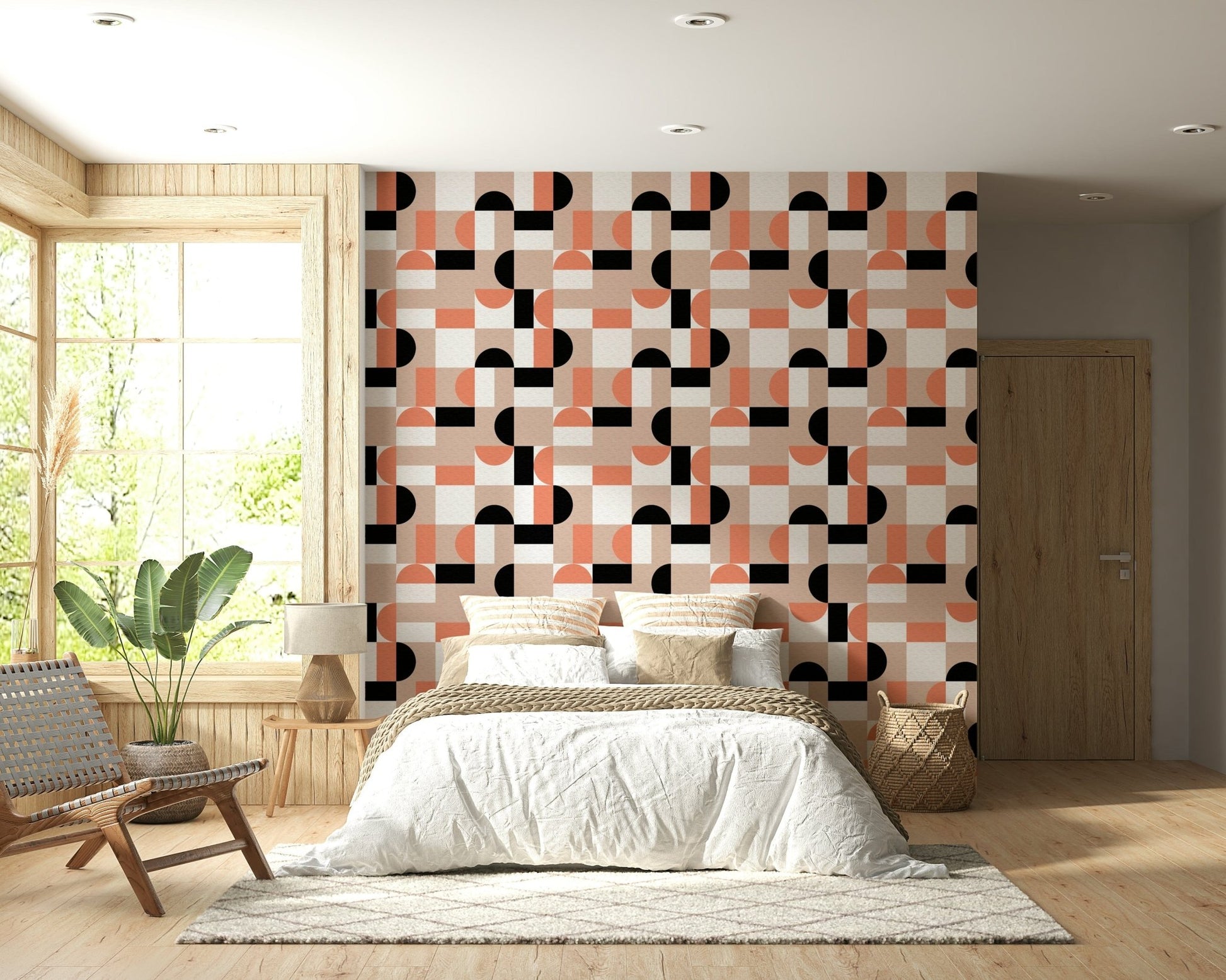 Blush Geometry wallpaper in pink and black above a bed with rattan bench in a wood-panelled bedroom