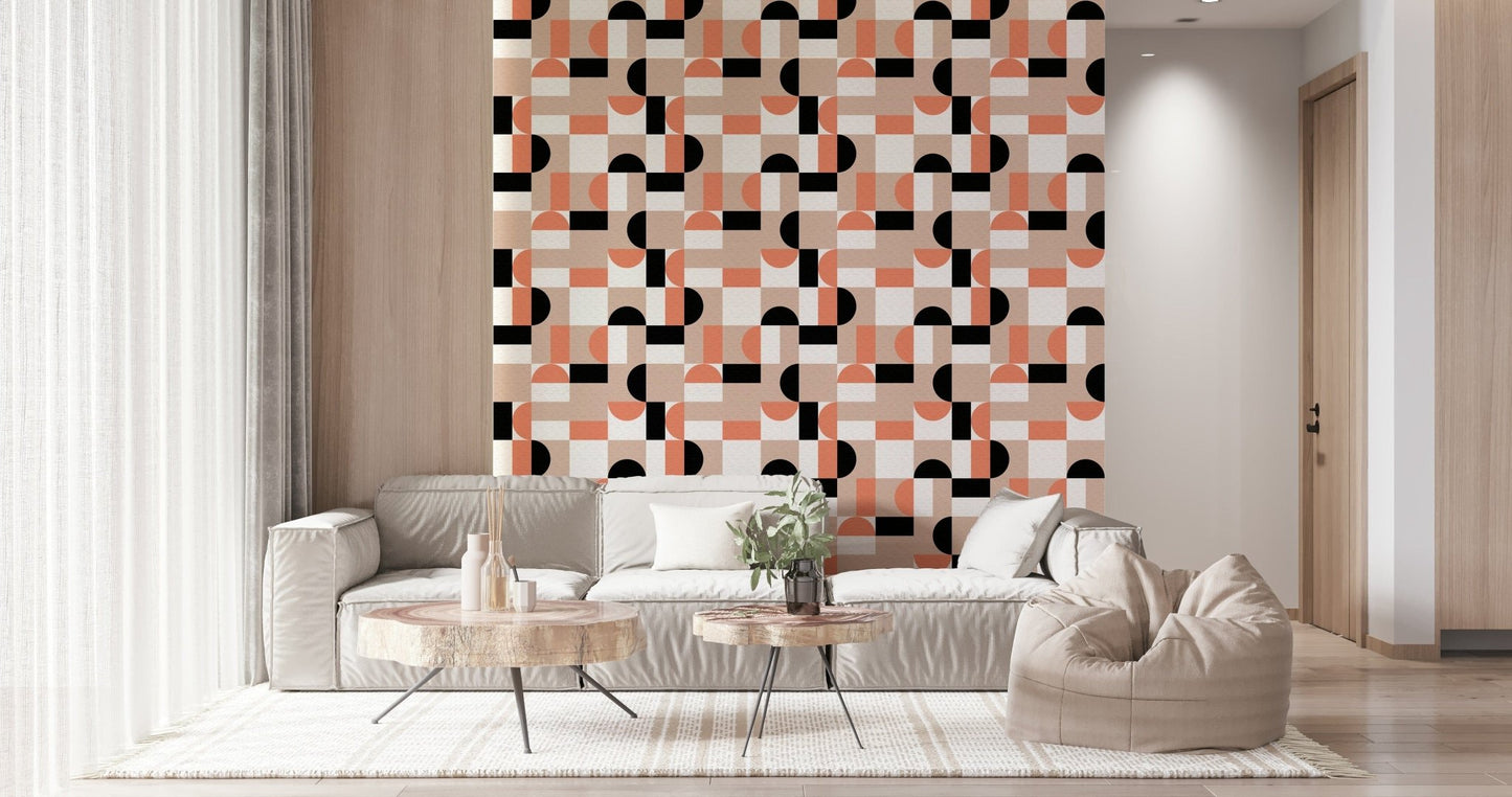 Blush Geometry wallpaper with coral and black shapes behind a cream sofa and beanbag in a cozy living room
