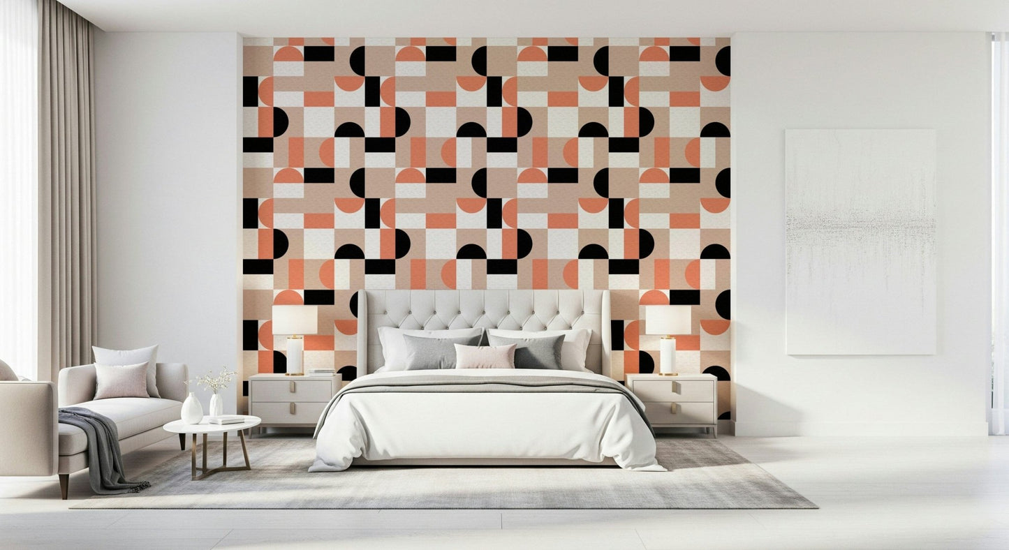 Blush Geometry wallpaper in coral and black behind a grey upholstered headboard in a bright white bedroom