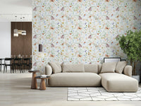Blush Meadow's Whisper wallpaper of blush florals and butterflies behind a beige sectional sofa near a dining area