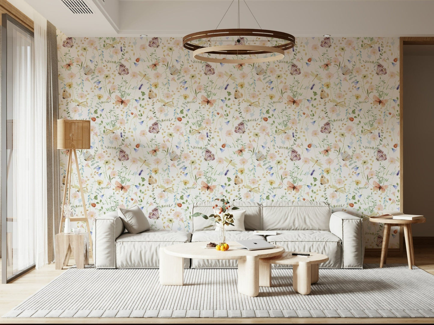Blush Meadow's Whisper wallpaper of blush wildflowers behind a low grey sofa with a round wood chandelier