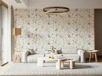 Blush Meadow's Whisper wallpaper of blush wildflowers behind a low grey sofa with a round wood chandelier