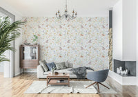 Blush Meadow's Whisper wallpaper with watercolor wildflowers and butterflies behind a beige sofa and grey chair