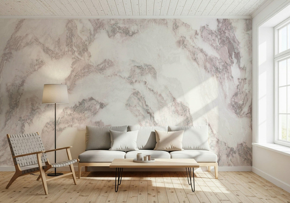 Blush Stone Texture wallpaper mural in soft pink veined marble behind a grey sofa and woven leather lounge chair