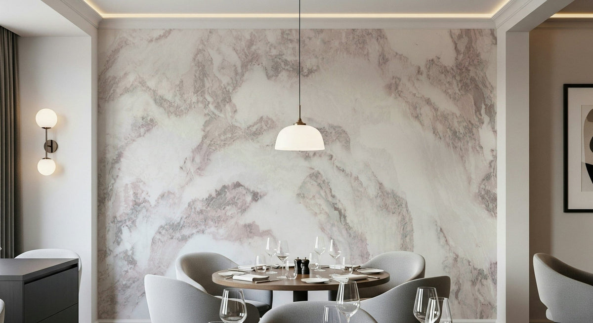 Blush Stone Texture wallpaper mural in pink-veined marble behind a round dining table set with wine glasses