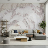Blush Stone Texture wallpaper mural in pink-veined marble behind a grey L-sectional, brass etagere and fiddle-leaf fig