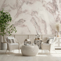 Blush Stone Texture wallpaper mural in blush marble behind white wicker armchairs and a woven table in a sunroom