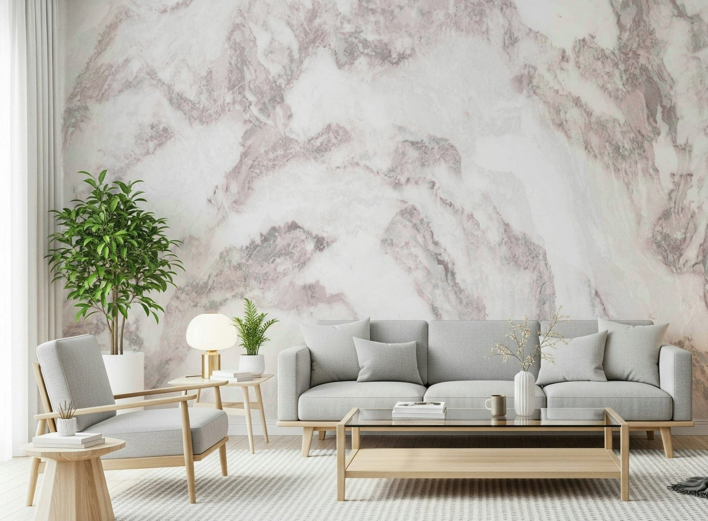 Blush Stone Texture wallpaper mural in pink marble behind a grey sectional with mustard and navy pillows