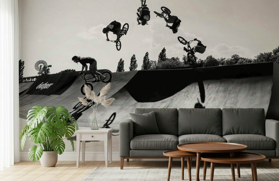 Monochrome BMX: Shadow & Style wallpaper mural of a black-and-white backflip sequence above a charcoal sofa in a living room